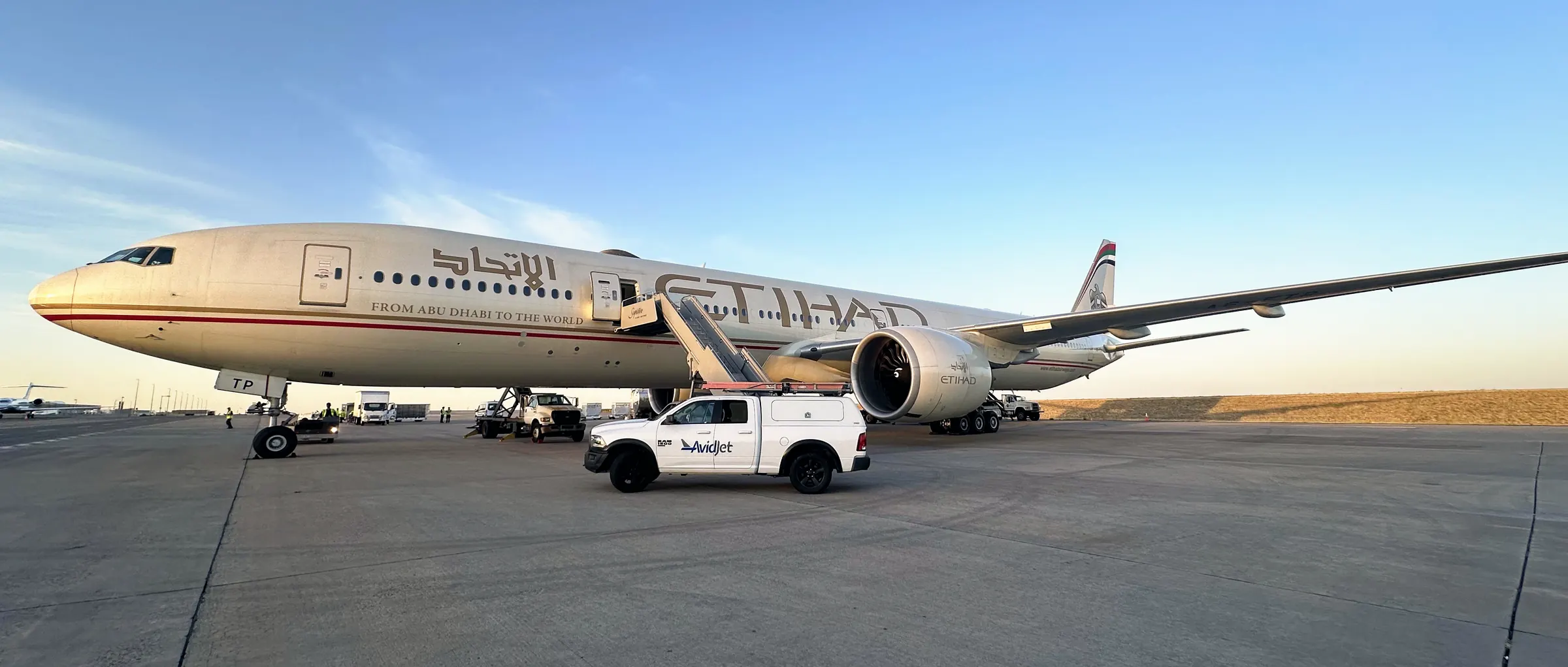 AvidJet technician cleaning an aircraft fuselage
