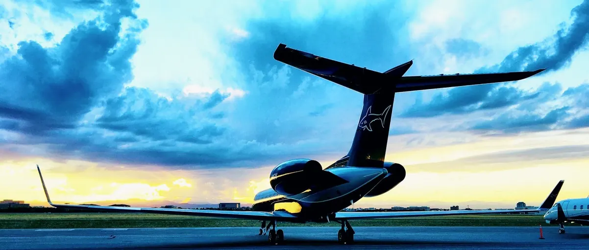 AvidJet team beside a business jet