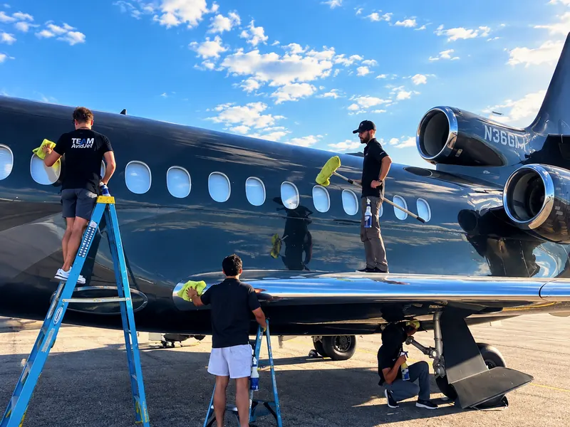 Technician washing an aircraft exterior